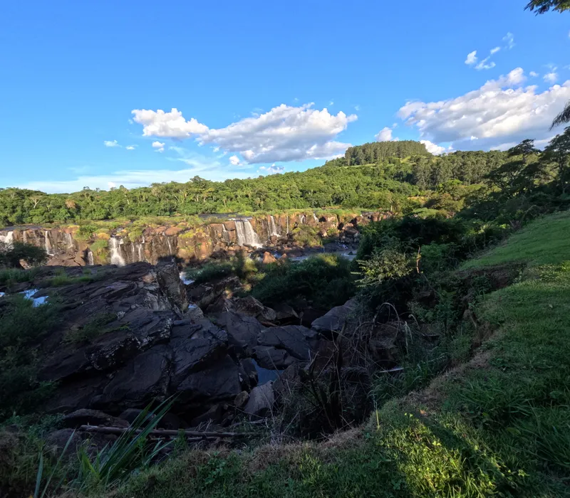 The Salto Saudades waterfall below green hills