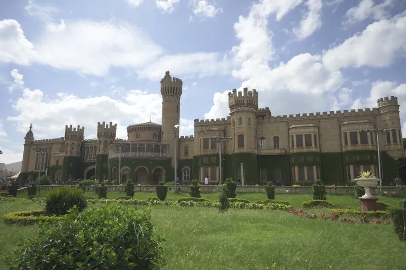 The front of Bangalore Palace behind its gardens