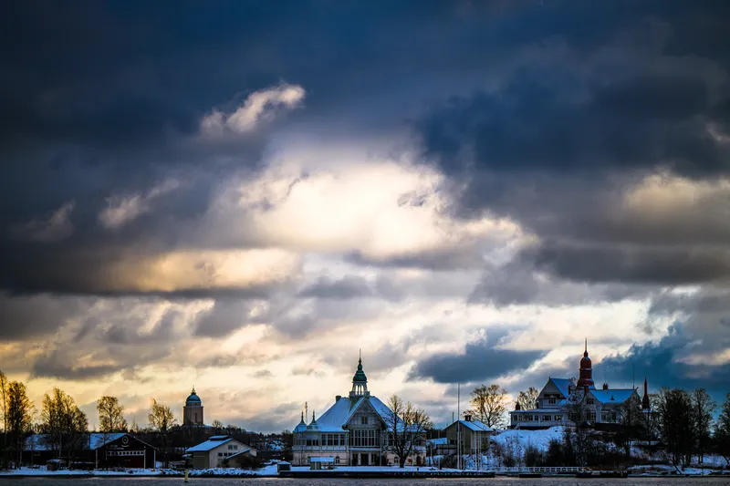 Dramatic clouds over buildings on a shoreline