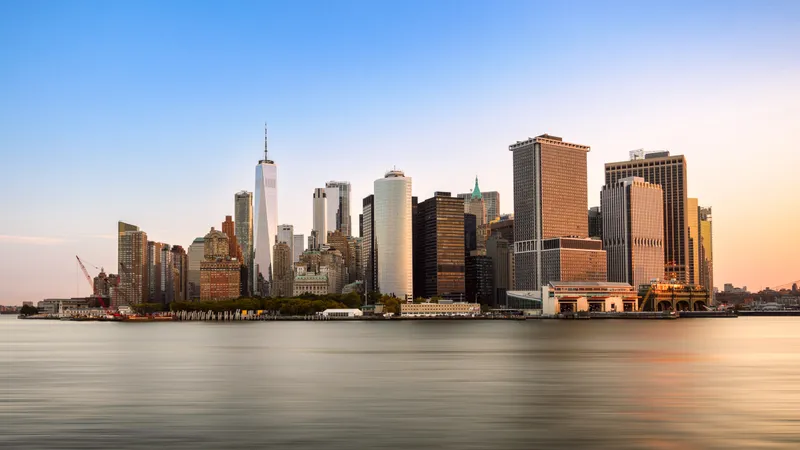 The Lower Manhattan skyline across the water at sunrise