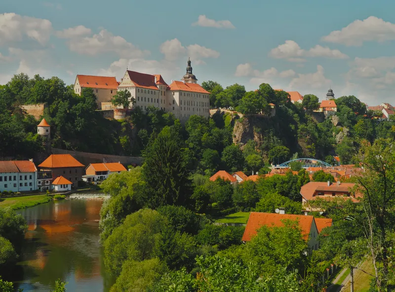 The town of Bechyně on a wooded hill above a river