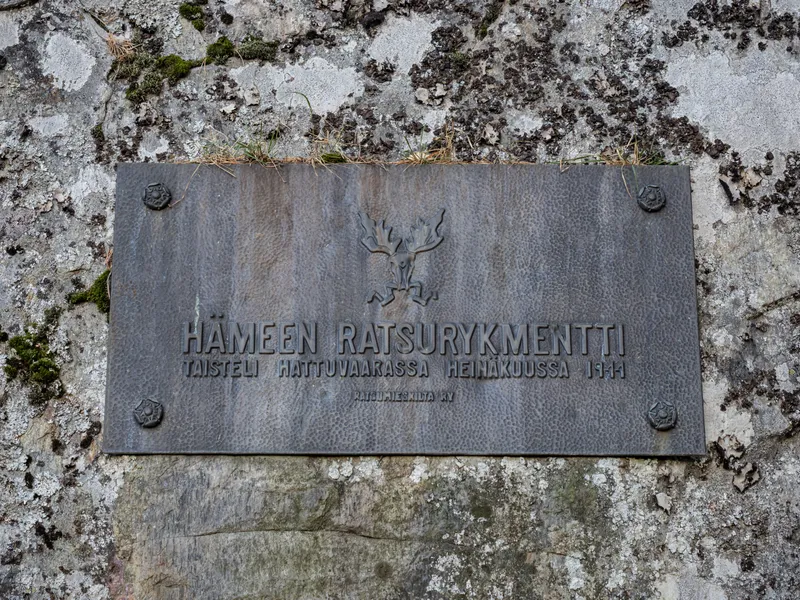 A memorial plaque set into a lichen-covered rock
