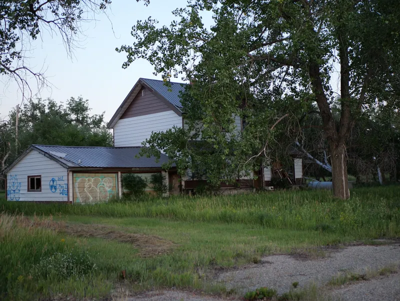 An abandoned house among trees in Bounty, Saskatchewan