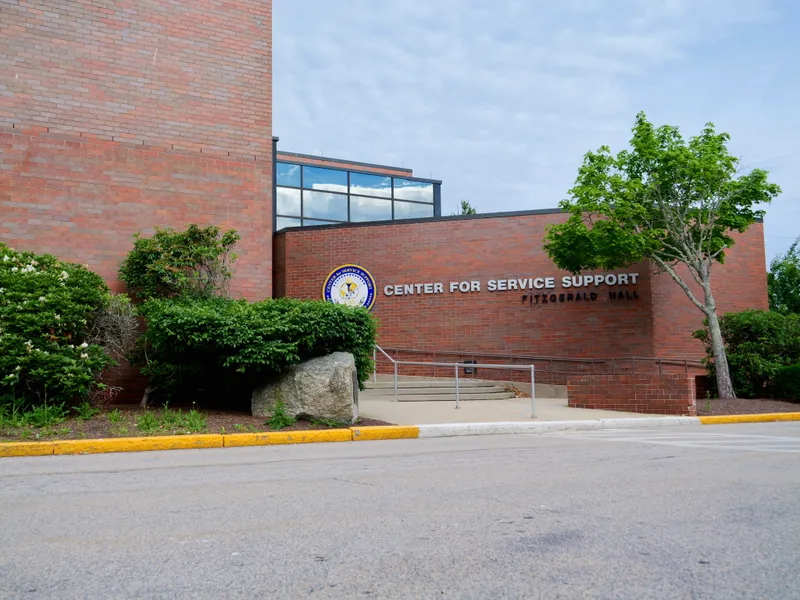 A brick building with a sign reading Center for Service Support