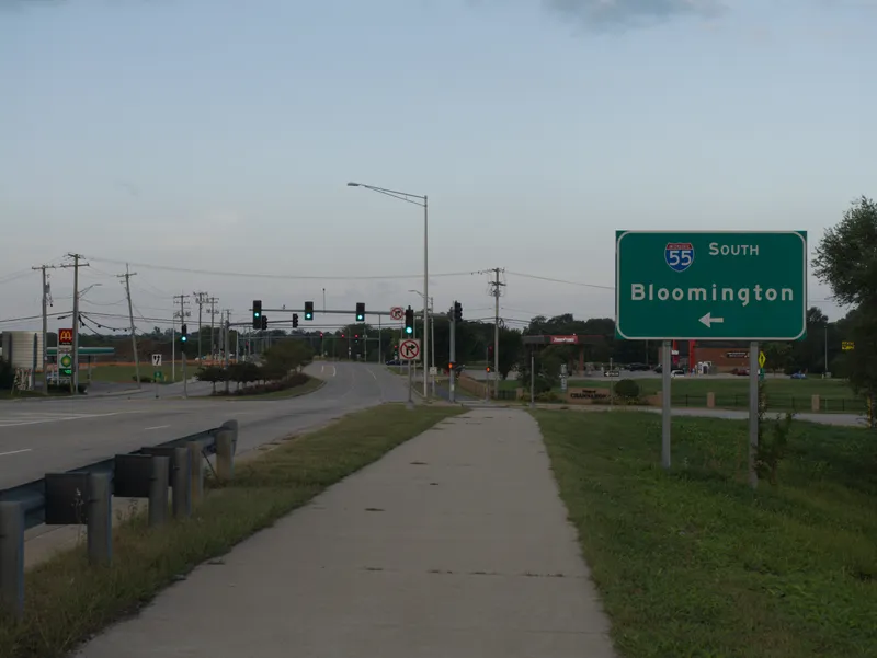 A sidewalk, a road junction and an I-55 sign at dawn in Channahon, Illinois