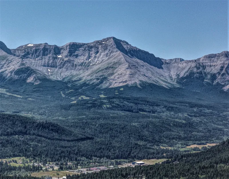 Chinook Peak above a forested valley in the Flathead Range