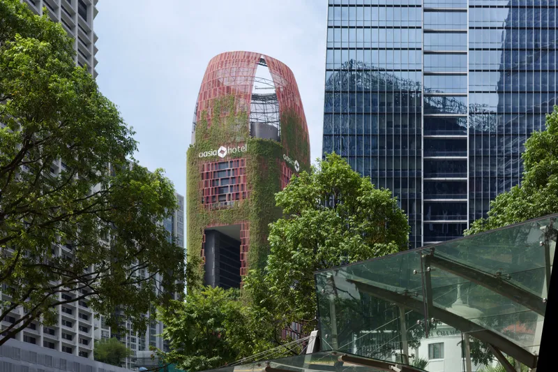 The red, plant-covered Oasia Hotel tower in Singapore