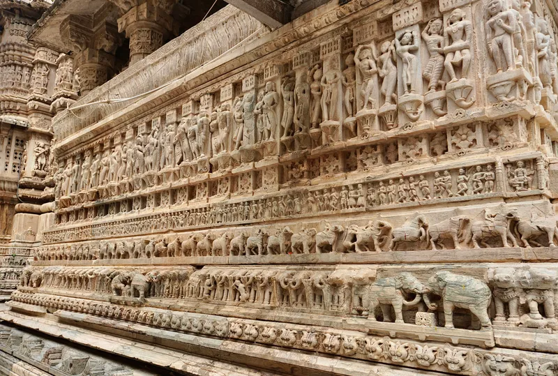Rows of elephant and figure carvings on a temple wall